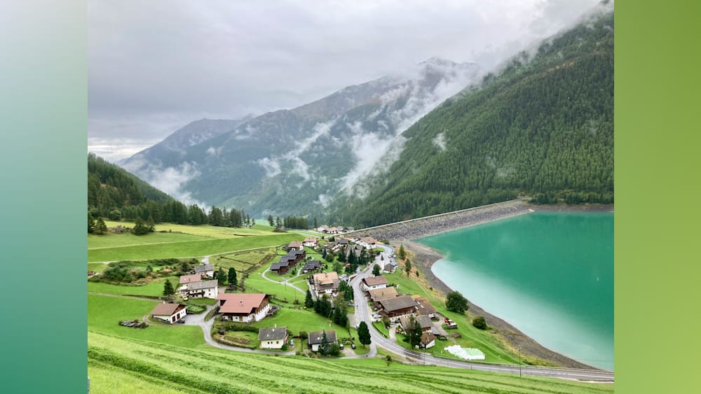 A village with a lake in the background is shown with the water being blue.