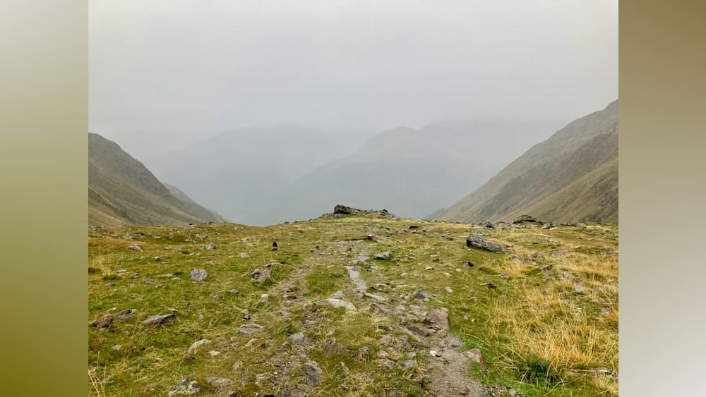 A rocky path winds up the side of a mountain.