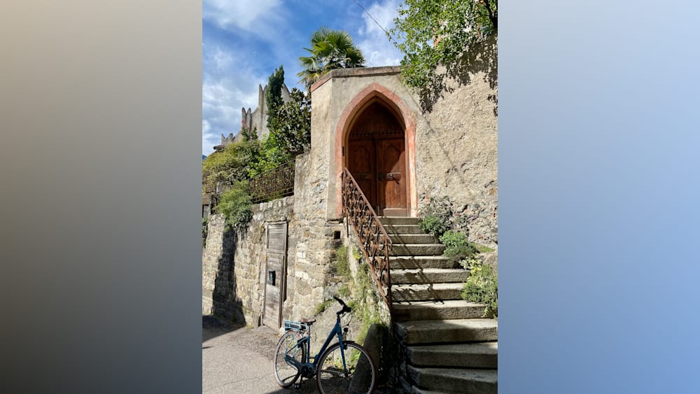 A set of stairs lead to a small arch door.
