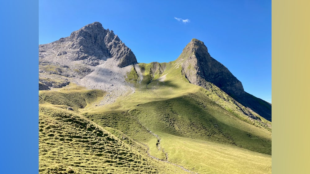 A mountain with a path going up and down it.