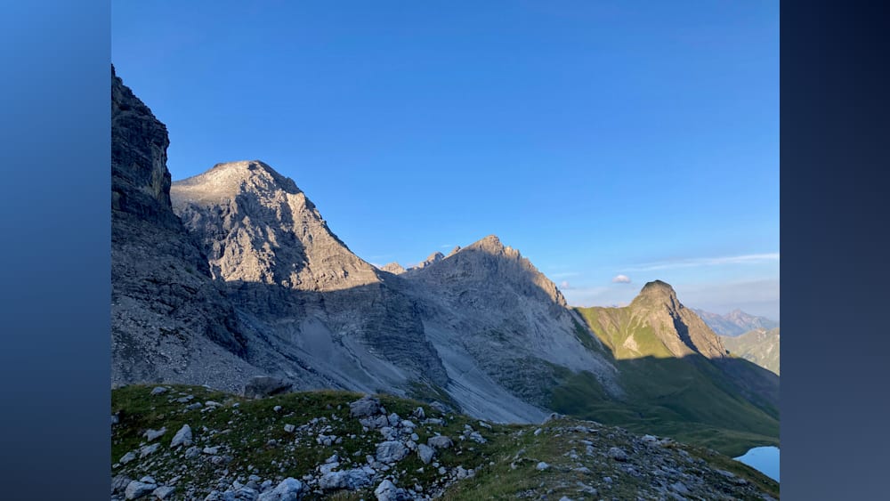 A mountain with a blue sky in the background.