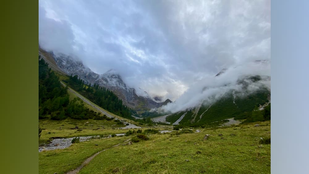 A misty mountain landscape with a path leading to the top.