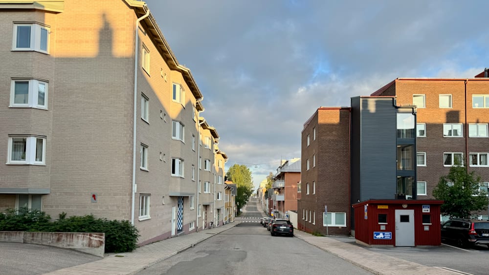a cross section of a city street with a car in the middle.