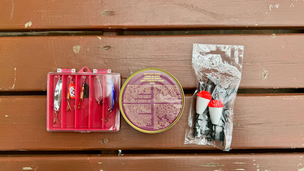 A table with a can of bait on it and a tin of fish on it.