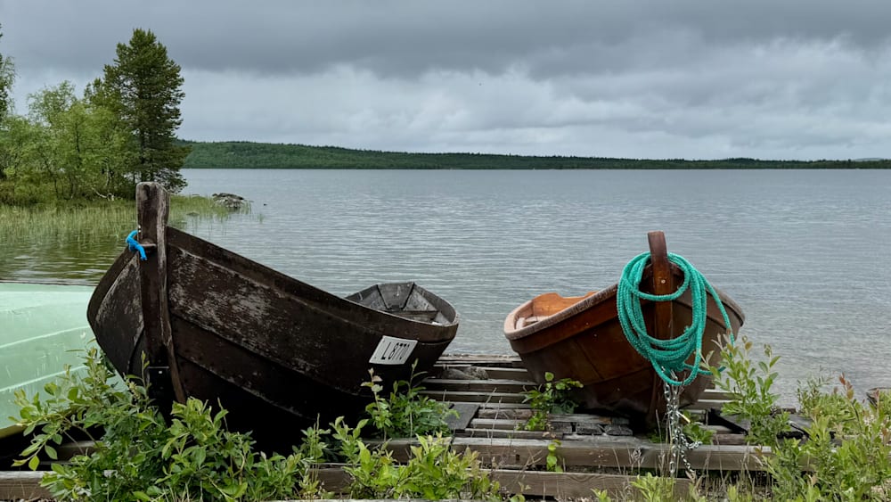A couple of boats are docked next to each other on a lake.