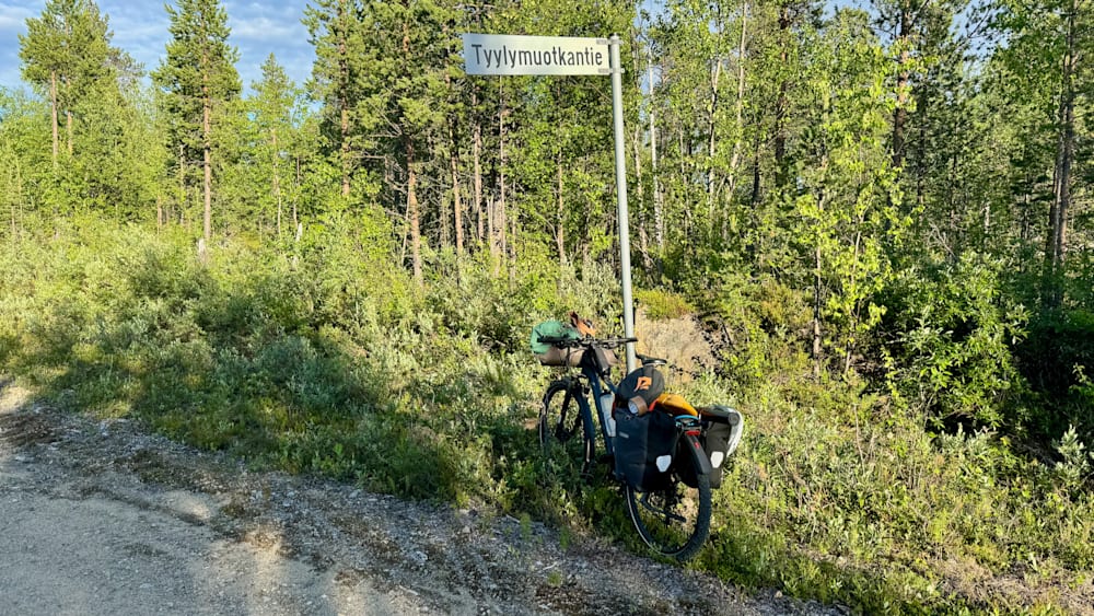 A bike is parked next to a sign that says Tylykuktie.