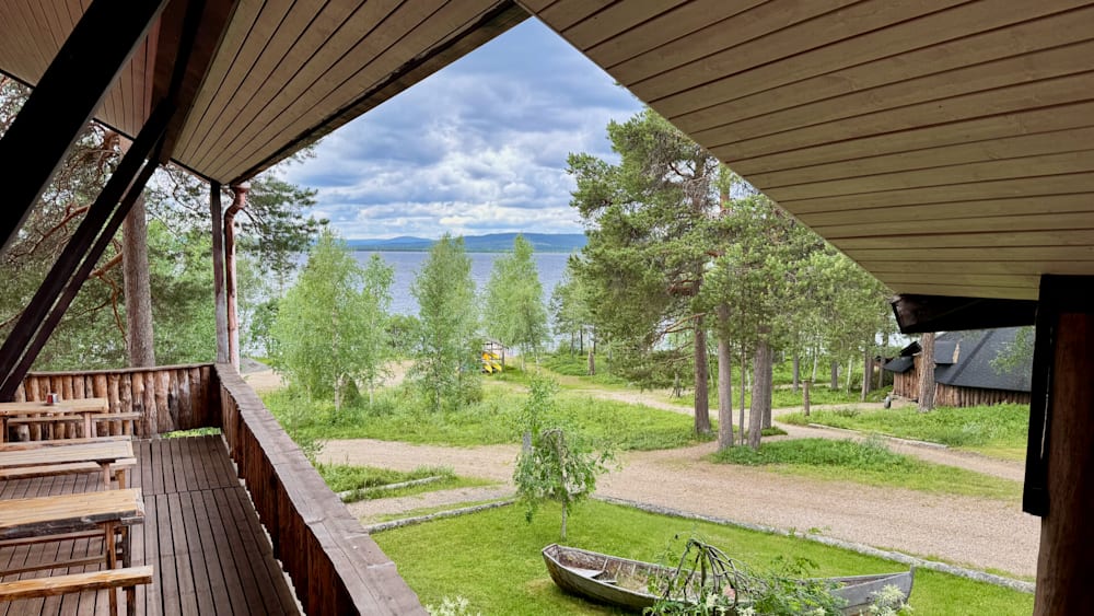 A boat is in the middle of a grassy field with trees.