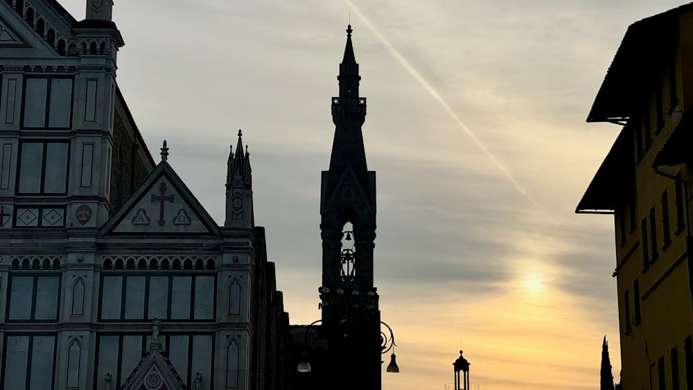 A church with a bell tower and a silhouette of a bell in the center of the church.