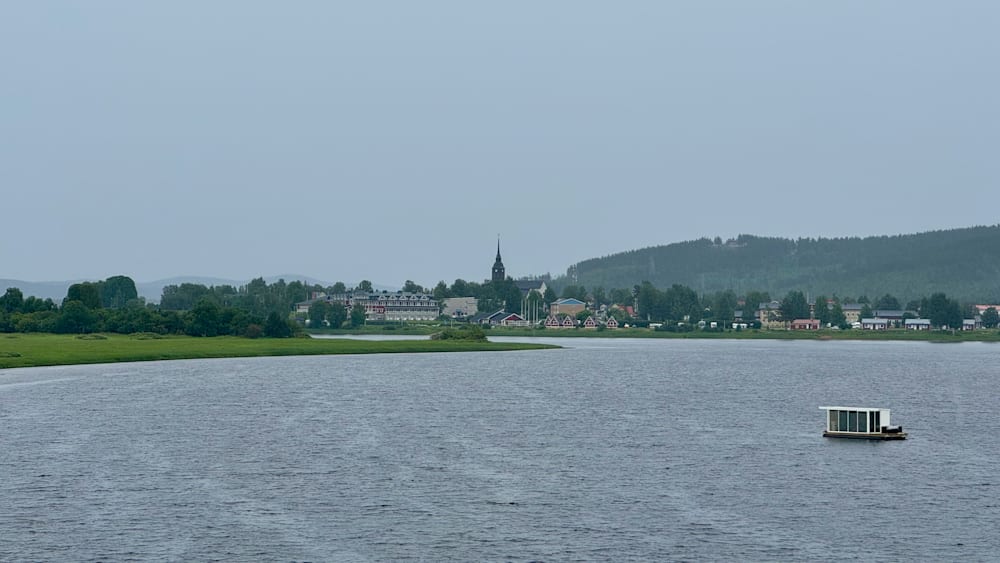 A body of water with a small island in the middle.