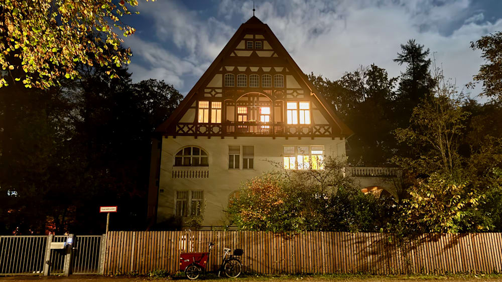 A house with a bike parked in front of it.