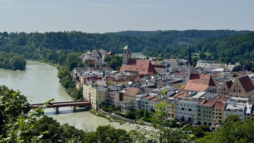 A cityscape with a river running through it, including a bridge spanning the river.