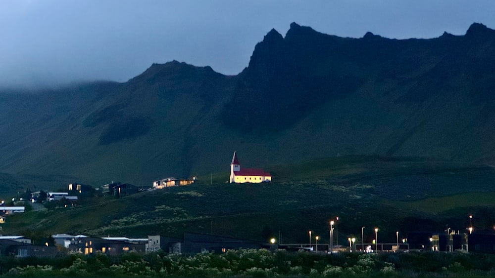 A church on a hill with a city in the valley below.