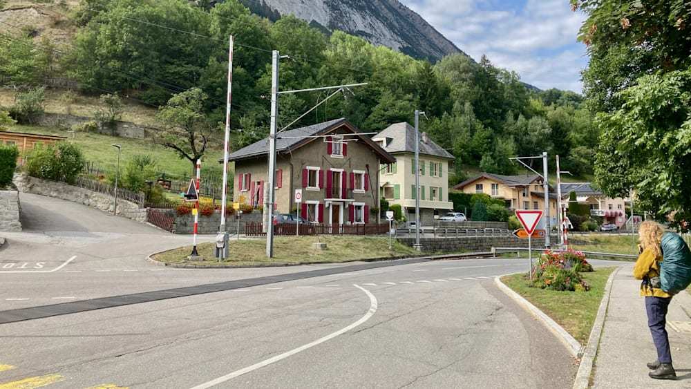 A street with a house at the end of it and a stop sign in front of it.