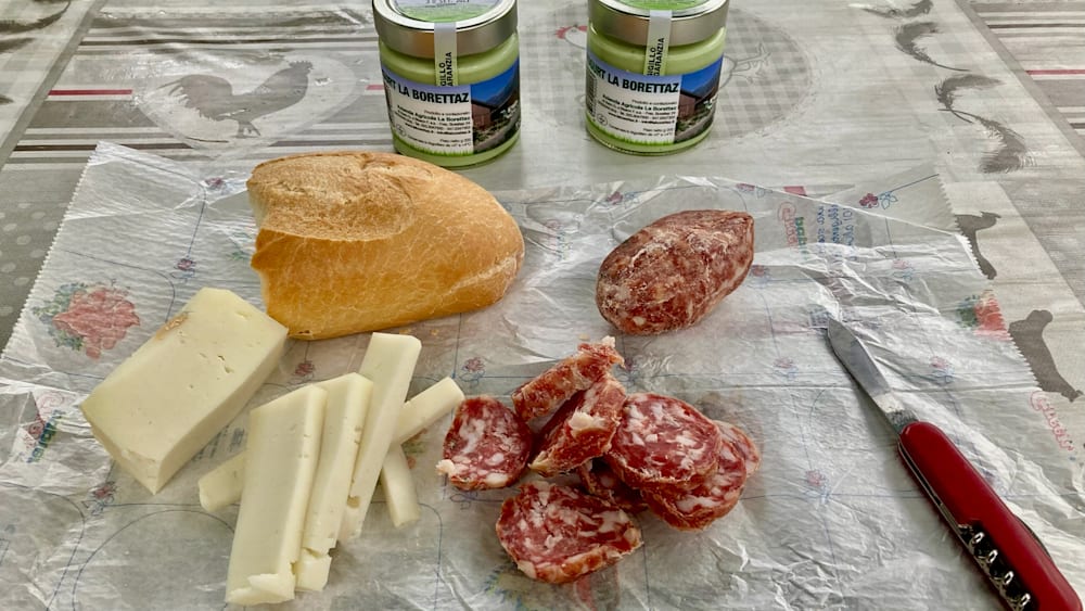 A table with various foods including some that look like meat and cheese.