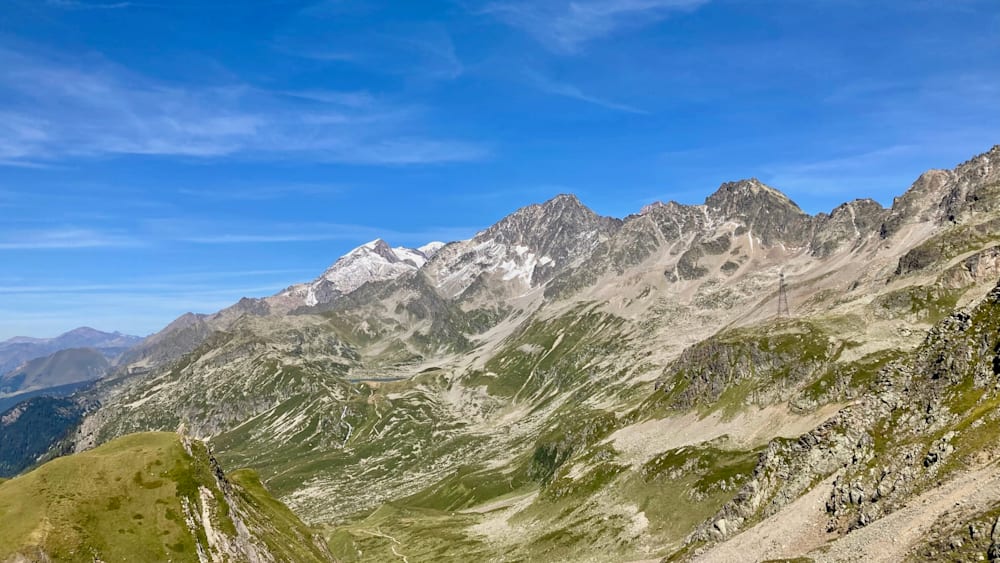 A mountain with a lake in it and a clear blue sky in the background.
