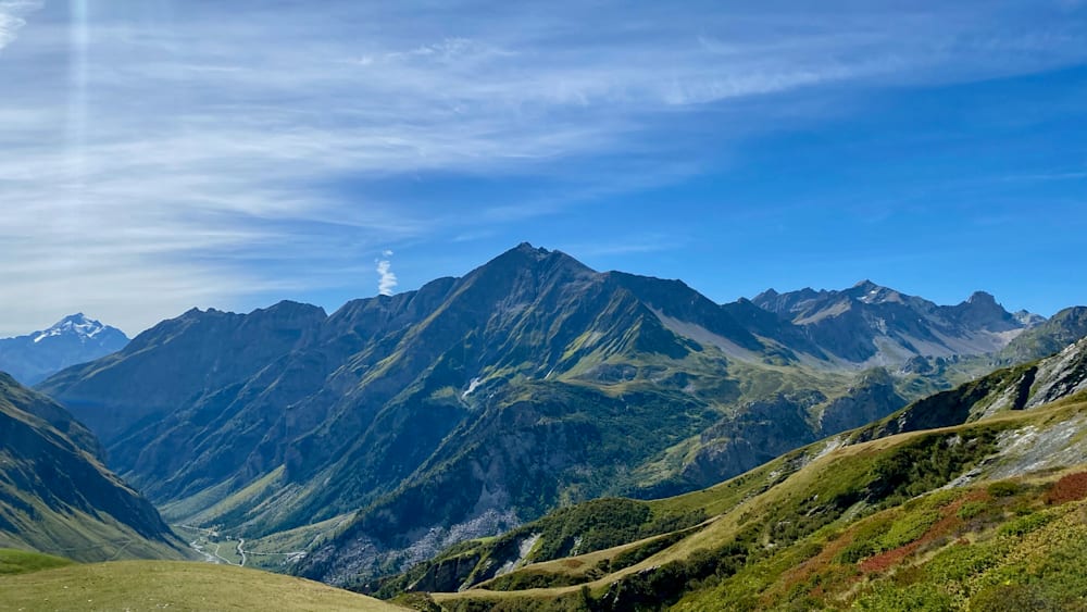 A mountain with a stream running down its side.