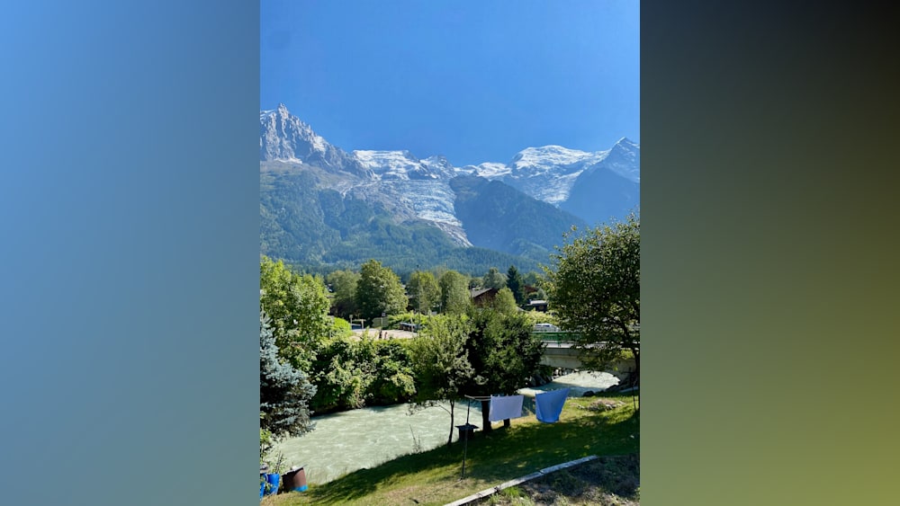 A mountain view with a bridge and some trees.