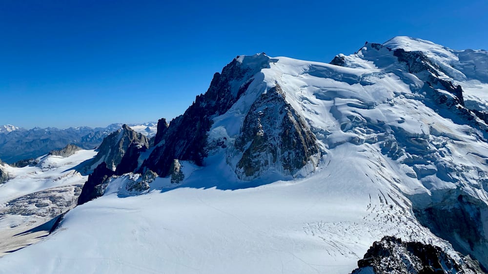 An aerial view of a mountain with snow on it.