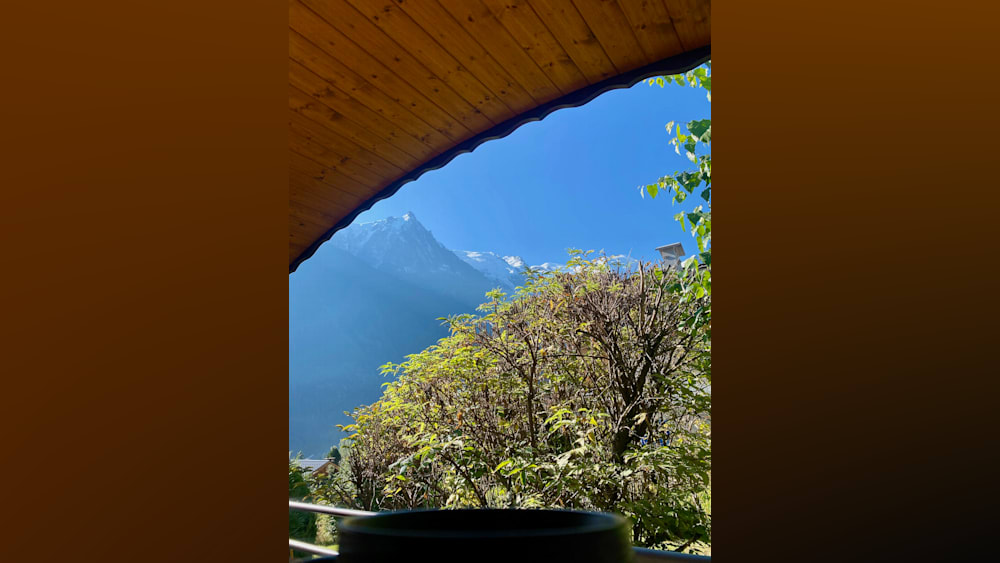 An archway leads to a beautiful view of the mountains.