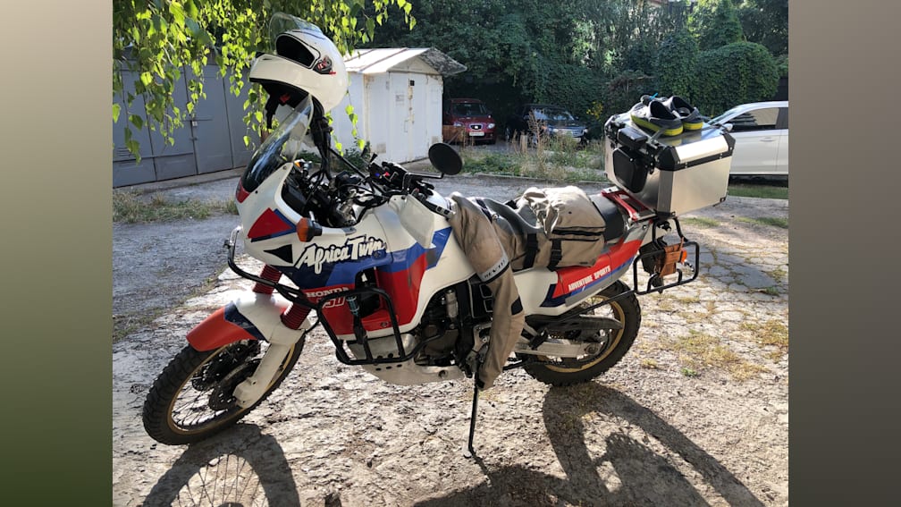 A white and red motorcycle with the word Africa Twin on it.