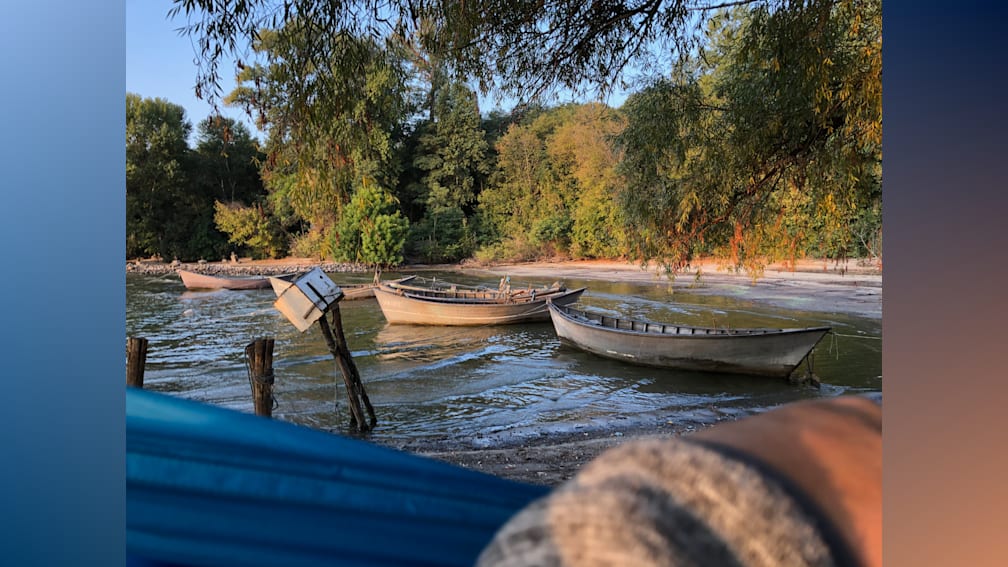 Three boats are in the water and they are blue in color.