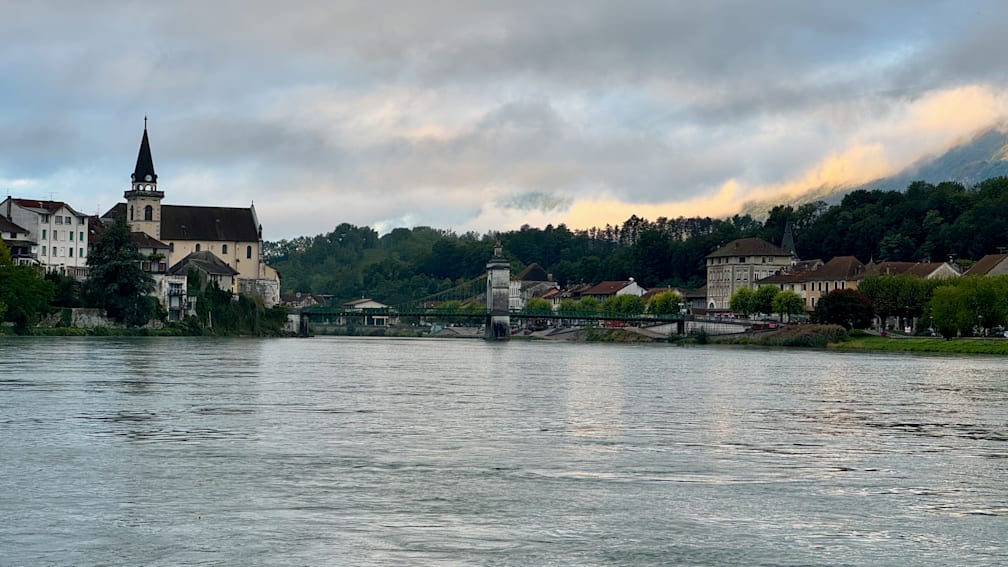 A bridge over a river with a town in the background.