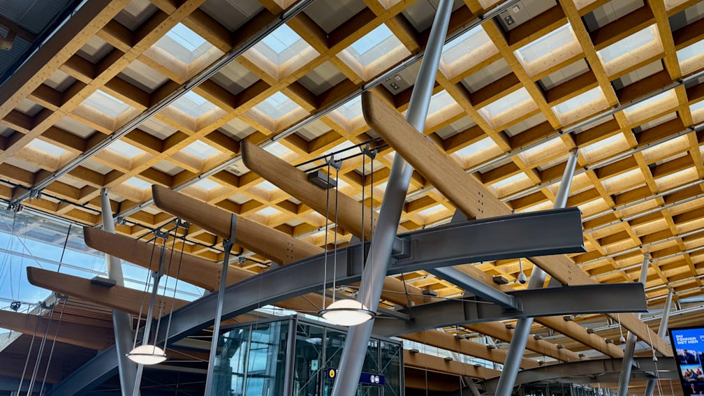 A metal and wood framed ceiling with lights installed.
