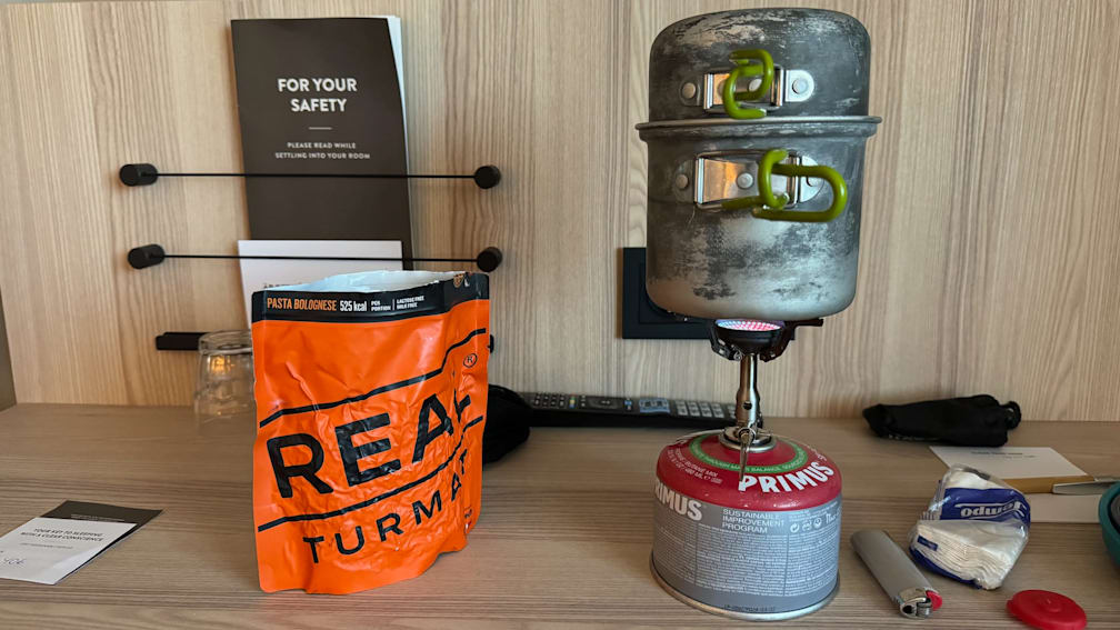 A small gas stove with a bag of real Turmat on the counter.