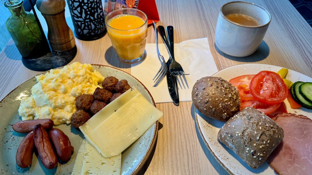 A table with plates of food and drinks on it.