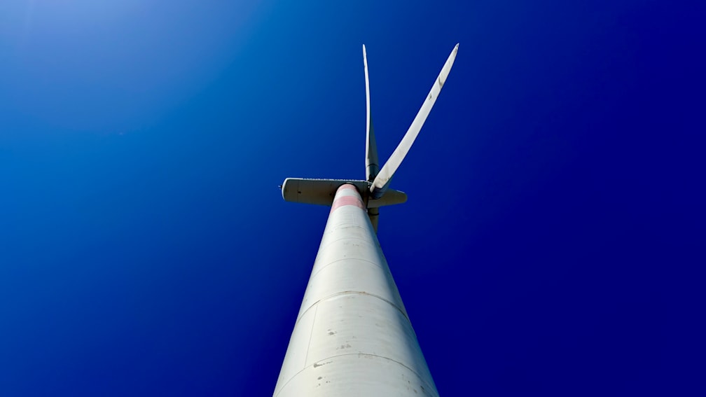 A large white windmill against a deep blue sky.