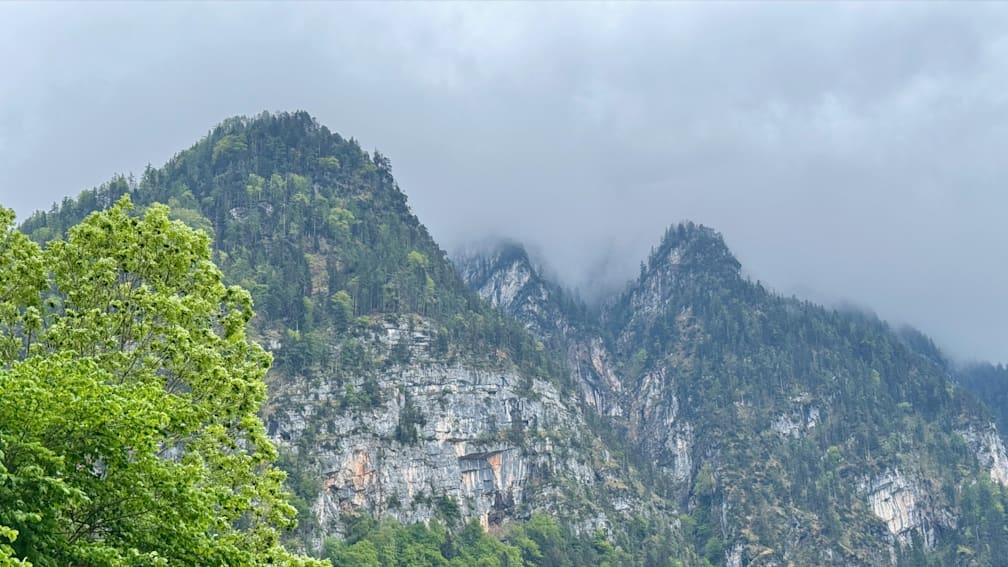 A mountain with a foggy atmosphere and a multitude of small pinpricks scattered throughout the mist.