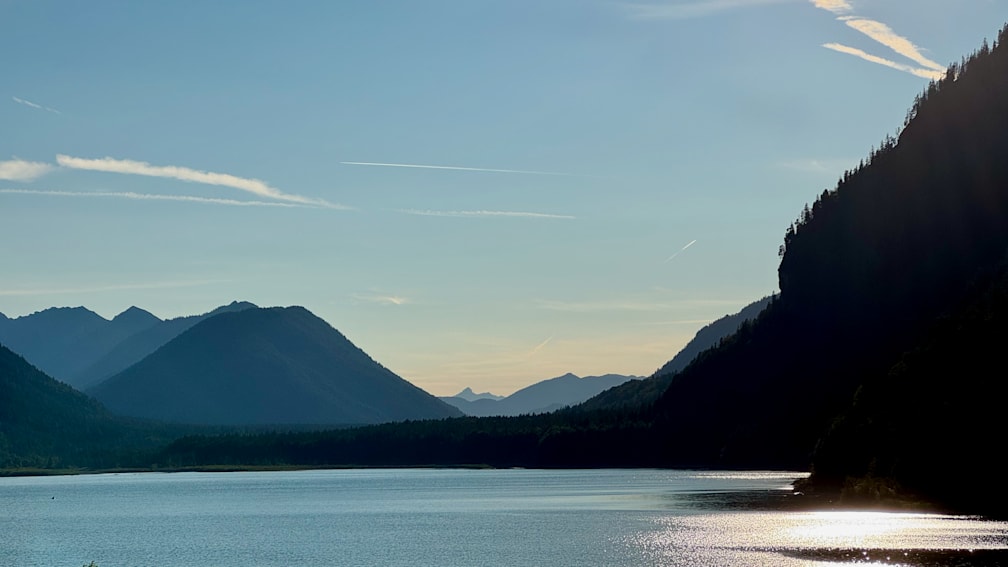 A beautiful mountain scene with a lake and mountains in the background.