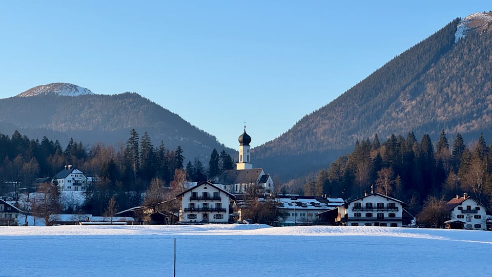 A church with a mountain in the background.