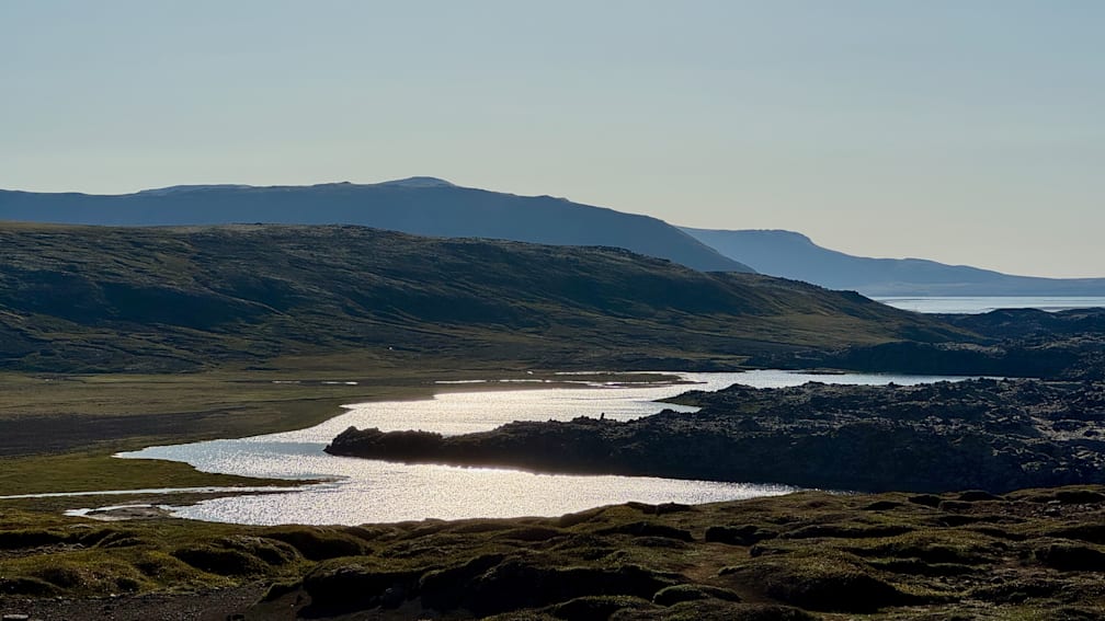 A river flows through a rocky, mountainous landscape.