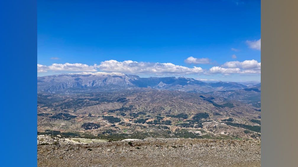 A mountain with a blue sky in the background.
