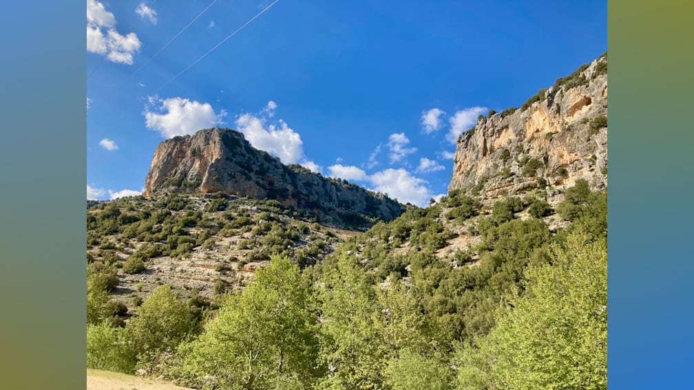 A mountain with a clear blue sky in the background.