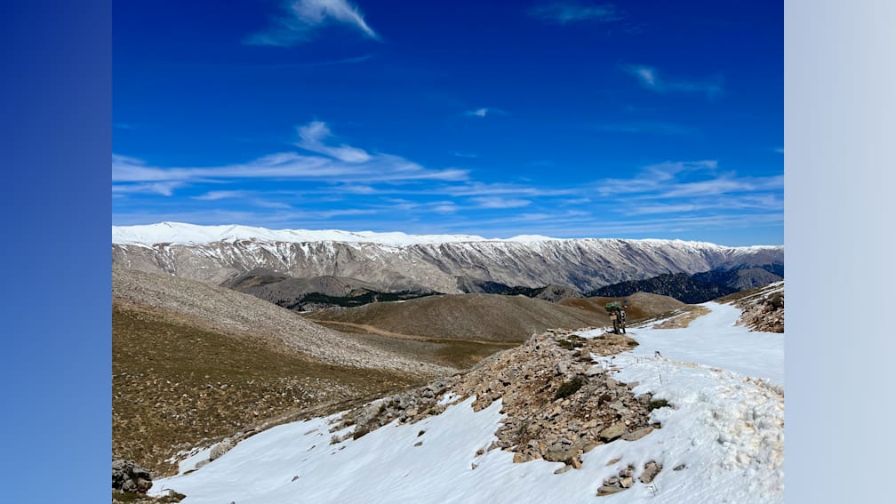 A mountain with a blue sky in the background.