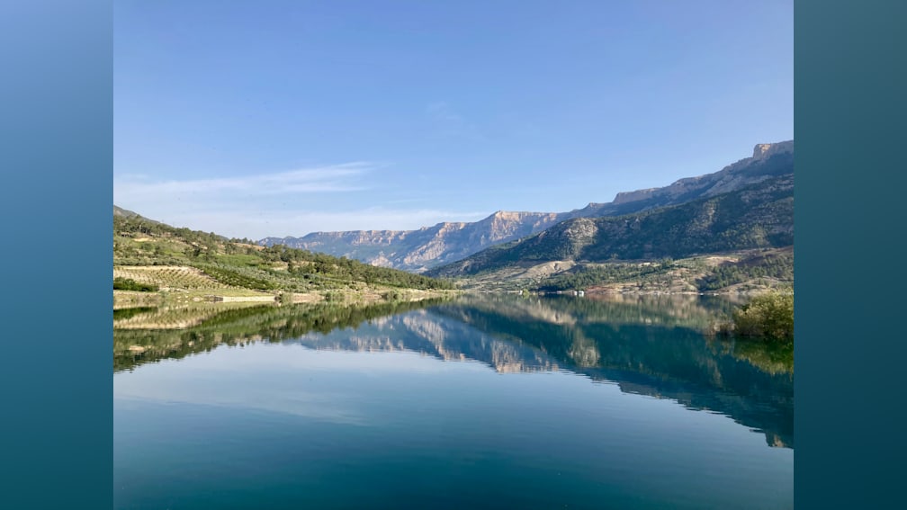 A large lake with a mountain in the background.