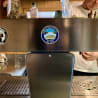 A shot of a glass wall with a large sticker saying "Sinnaun Hotel" on it.