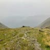 A rocky path winds up the side of a mountain.