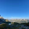 A mountain with a lake in the middle of it and the sky is blue with no clouds.