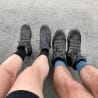 Two people with muddy boots sitting next to each other.