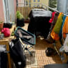 A patio with bags and a chair on it.