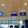 A Lufthansa infomation screen is above a D13 sign.