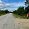 A road with no cars or people on it and a red mailbox on the side.