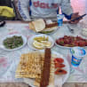 A man sits at a table with plates of food in front of him.