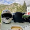 A helmet and a cup of soup are the only items on the table.