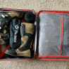 The inside of a suitcase with Heimox and other items in it.