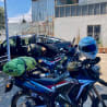 A motorcycle with a helmet on it and a dog on the back of it.