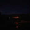 A dark sky filled with stars and a small town in the background.